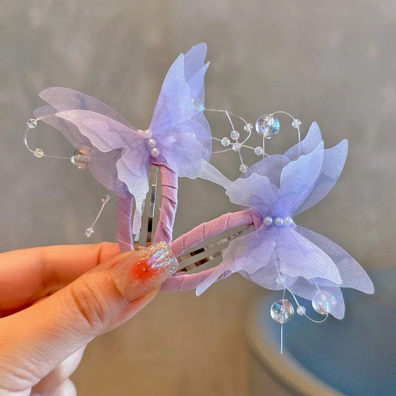Two gradient butterfly hair clips for girls and women, decorative hair accessories by R.E.D. Shopping, suitable for various hairstyles.