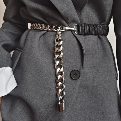 Women's elastic leather silver chain belt with stretch corset waistband, stylish accessory for modern outfits.