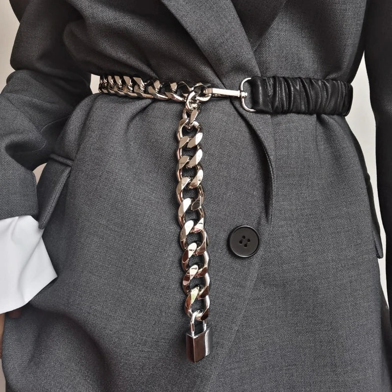 Women's elastic leather silver chain belt with stretch corset waistband, stylish accessory for trendy outfits.