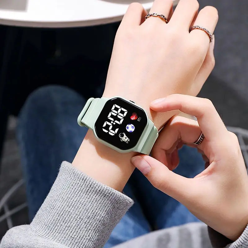 Kids LED digital sports watch with football design, silicone strap, suitable for boys and girls, by R.E.D. Shopping.