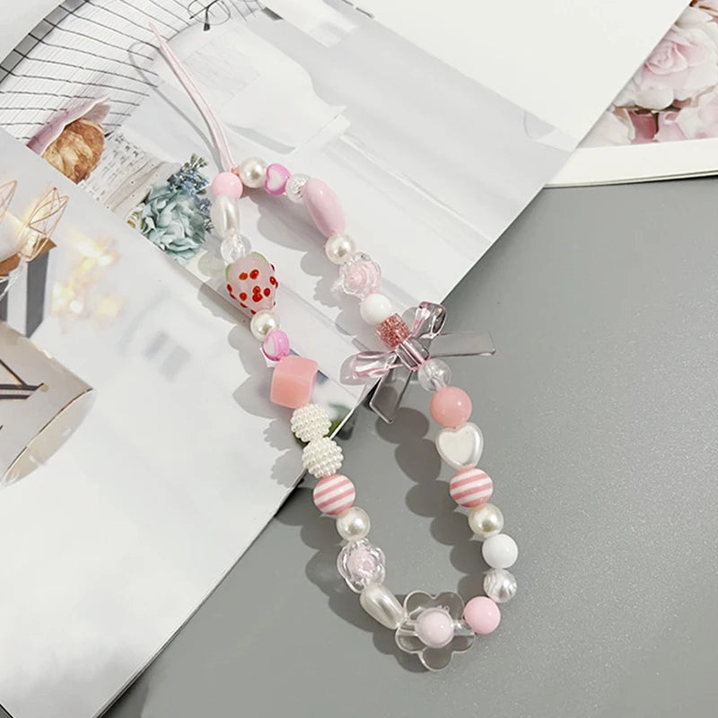 Sweet strawberry flower bead phone strap charm with pink beads and a small strawberry pendant, perfect for women and girls.