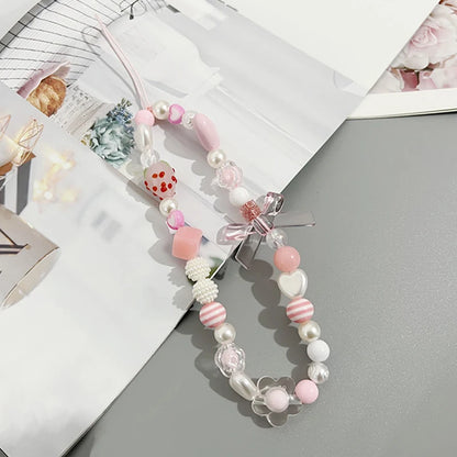 Sweet strawberry flower bead phone strap charm with pink beads and a small strawberry pendant, perfect for women and girls.