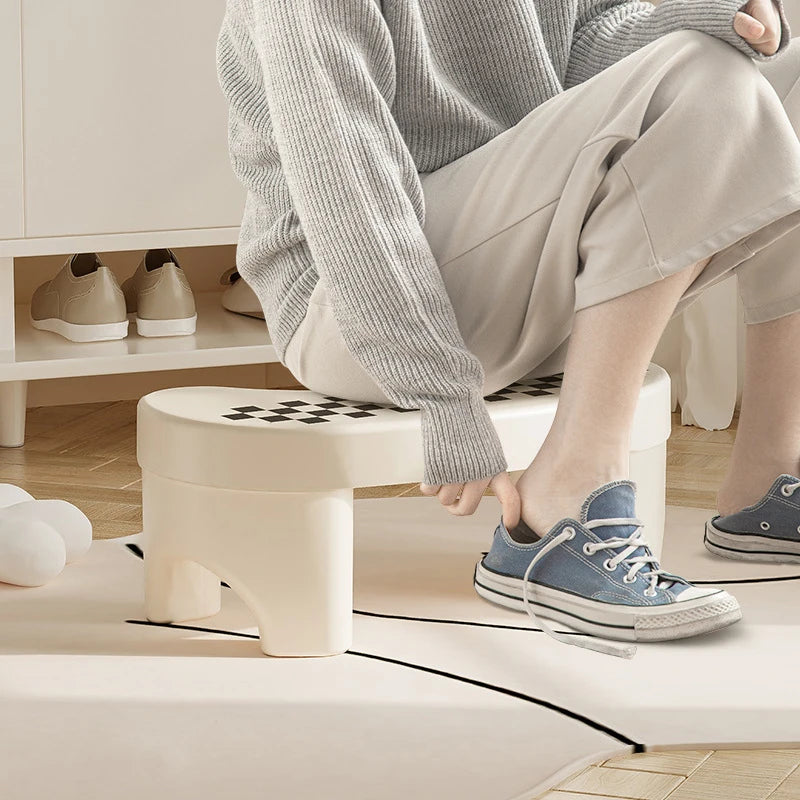 Plastic toilet stool footstool with non-slip pad, designed for children and adults, providing comfortable squatting in bathroom use.