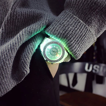 LED Flash Luminous Watch by R.E.D. Shopping featuring a silicone wristband and rhinestone accents, glowing in low light.
