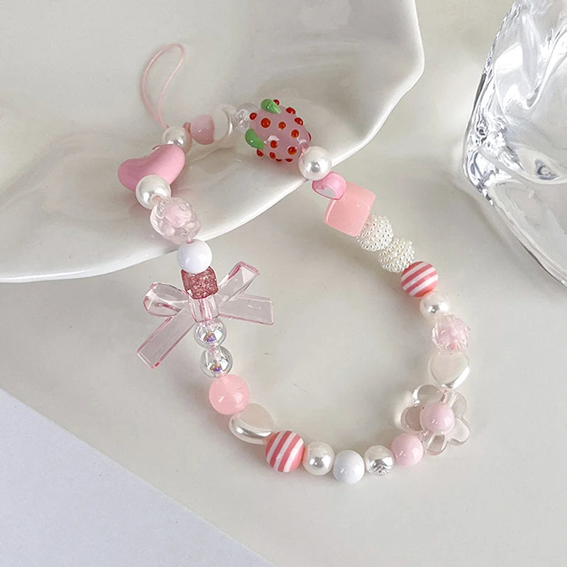 Sweet strawberry flower bead phone strap charm with pink beads and a small strawberry pendant, perfect for women and girls.