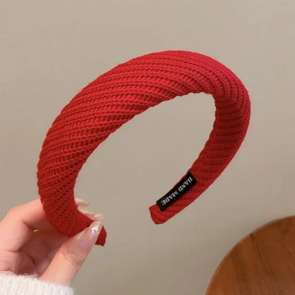 Red Christmas fashion headband with vintage wool style, festive cloth hair accessory for holiday celebrations.