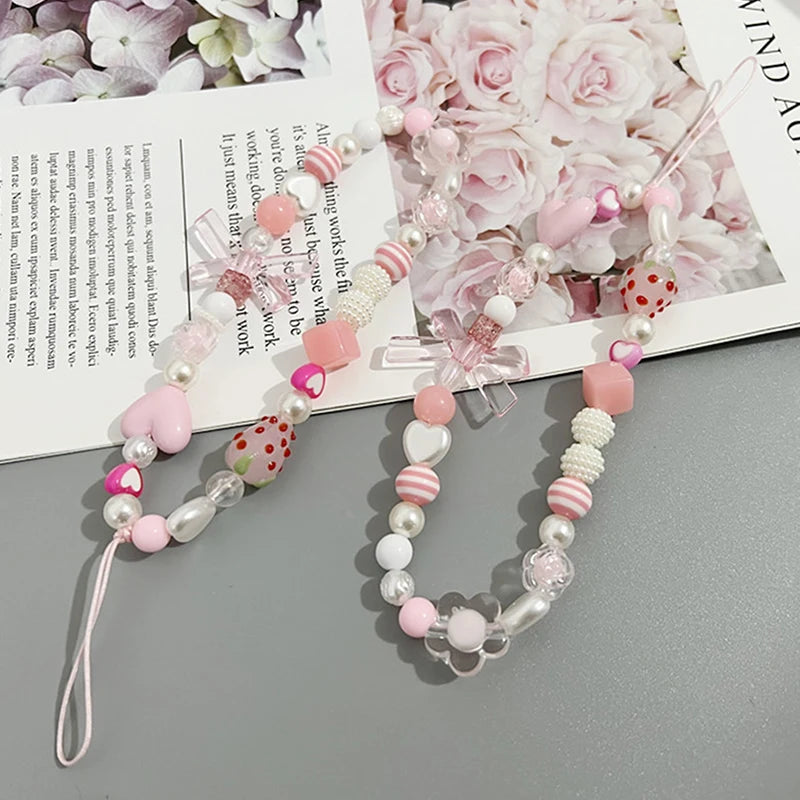 Sweet strawberry flower bead phone strap charm with pink beads and a keychain pendant, ideal as a bag or cellphone accessory for women.