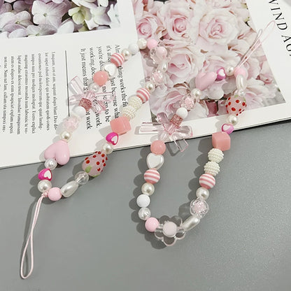 Sweet strawberry flower bead phone strap charm with pink beads and a keychain pendant, ideal as a bag or cellphone accessory for women.