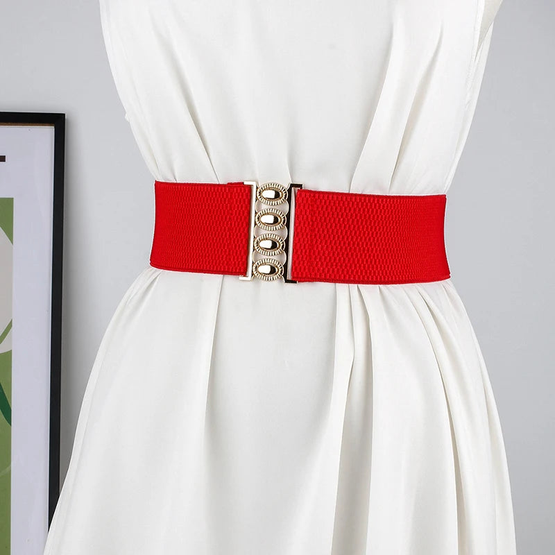 Women’s wide elastic waist belt with metal buckle, corset-style cinch belt in black, from R.E.D. Shopping, shown on a model.