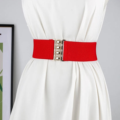 Women’s wide elastic waist belt with metal buckle, corset-style cinch belt in black, from R.E.D. Shopping, shown on a model.