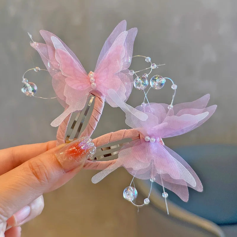 Two gradient butterfly hair clips from R.E.D. Shopping, stylish accessories for girls and women with colorful, decorative design.