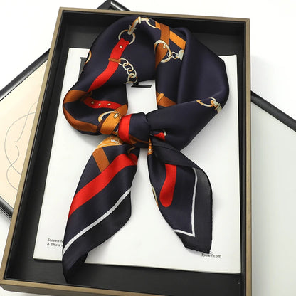 Elegant square silk scarf by R.E.D. Shopping, styled as a hairband and neck shawl, with vibrant patterns and smooth fabric.