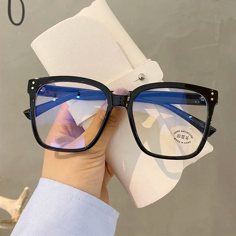 R.E.D. Shopping blue light blocking glasses for men and women, stylish computer eyewear with clear lenses and black frames.