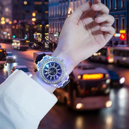 LED Flash Luminous Watch by R.E.D. Shopping with rhinestones and silicone band, showing the watch face and glowing light in low light.