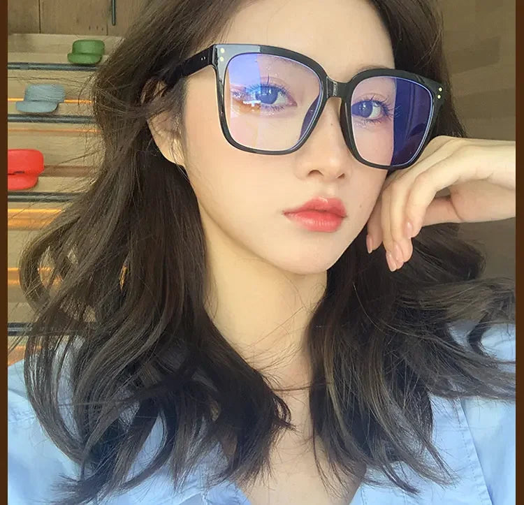 R.E.D. Shopping anti-blue light glasses for men and women, stylish computer eyewear with clear lenses and black frames.