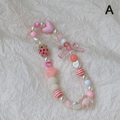 Sweet strawberry flower bead phone strap charm with pink beads and a small strawberry, attached to a cellphone lanyard for women