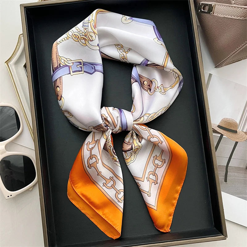 Elegant square silk scarf from R.E.D. Shopping, styled as a women's hairband and neck shawl, with vibrant patterns and smooth fabric.